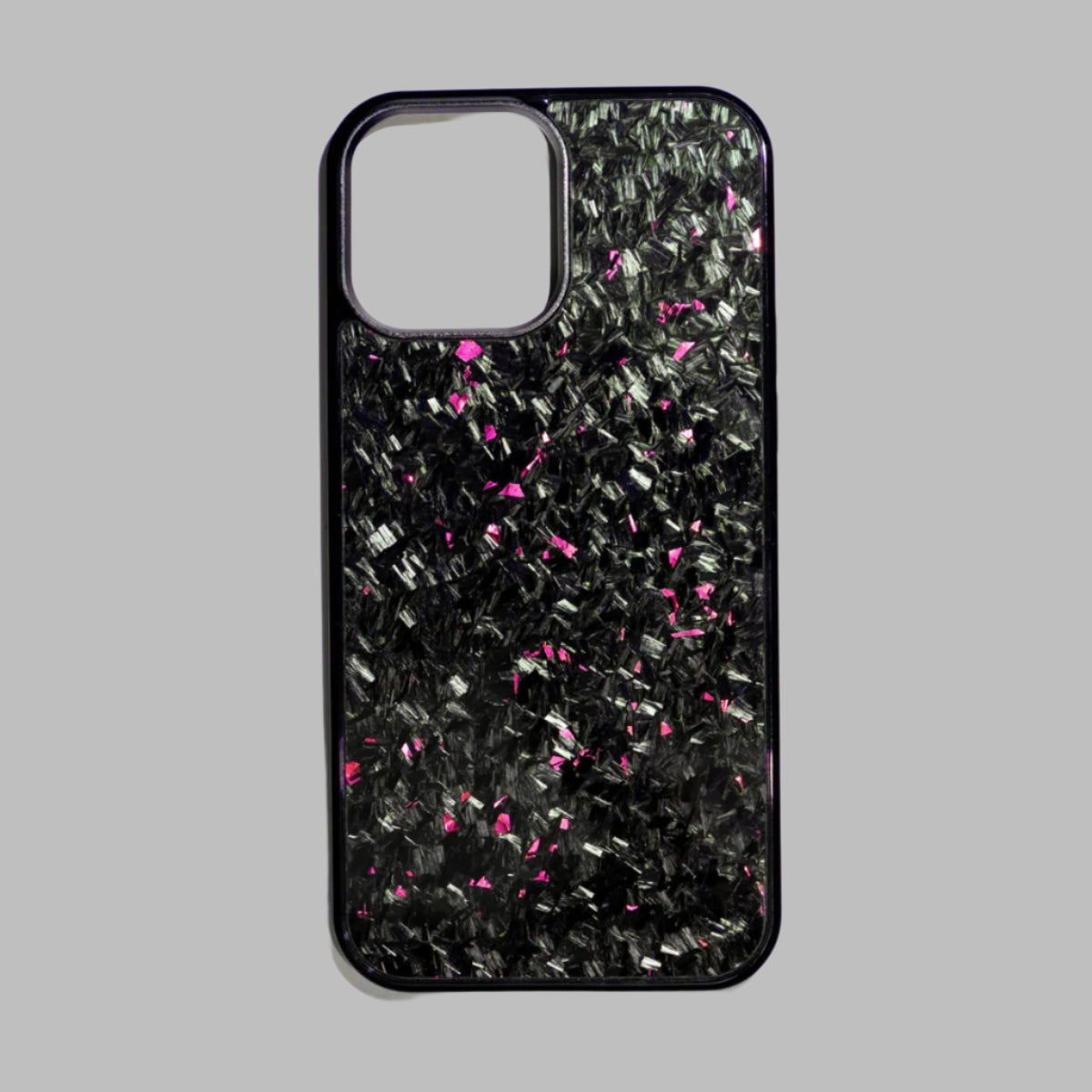 Phone case with black and pink speckled pattern on a white background